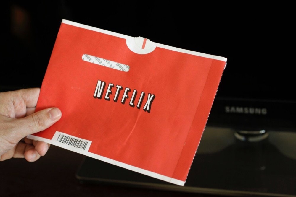 照片中提到了NETFLIX、SAMSUNG，跟網飛有關，包含了Netflix著名的紅包、郵寄 DVD、DVD