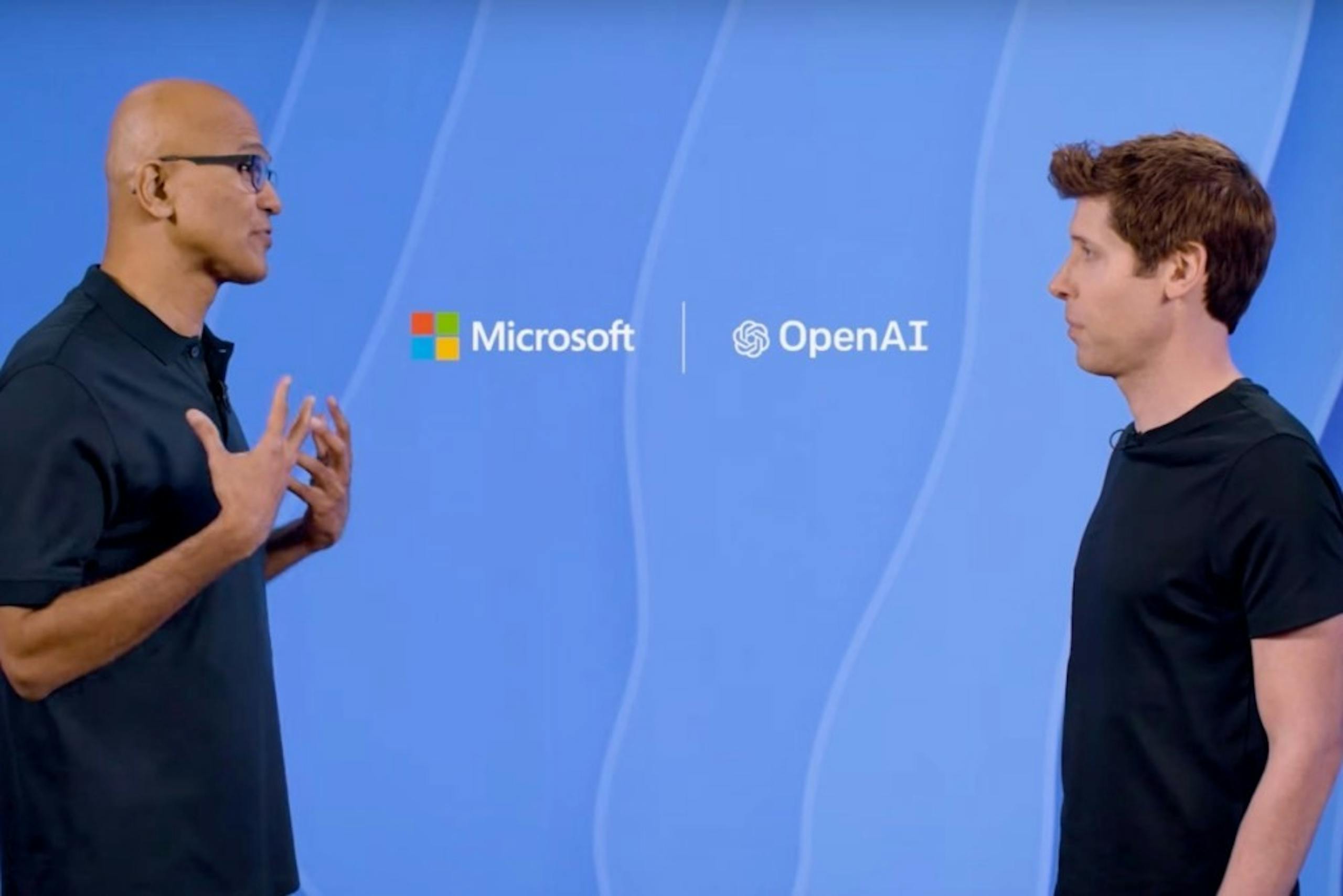 照片中提到了Microsoft、OpenAI，跟開放AI、微軟公司有關，包含了T卹、山姆奧特曼、薩蒂亞·納德拉（Satya Nadella）