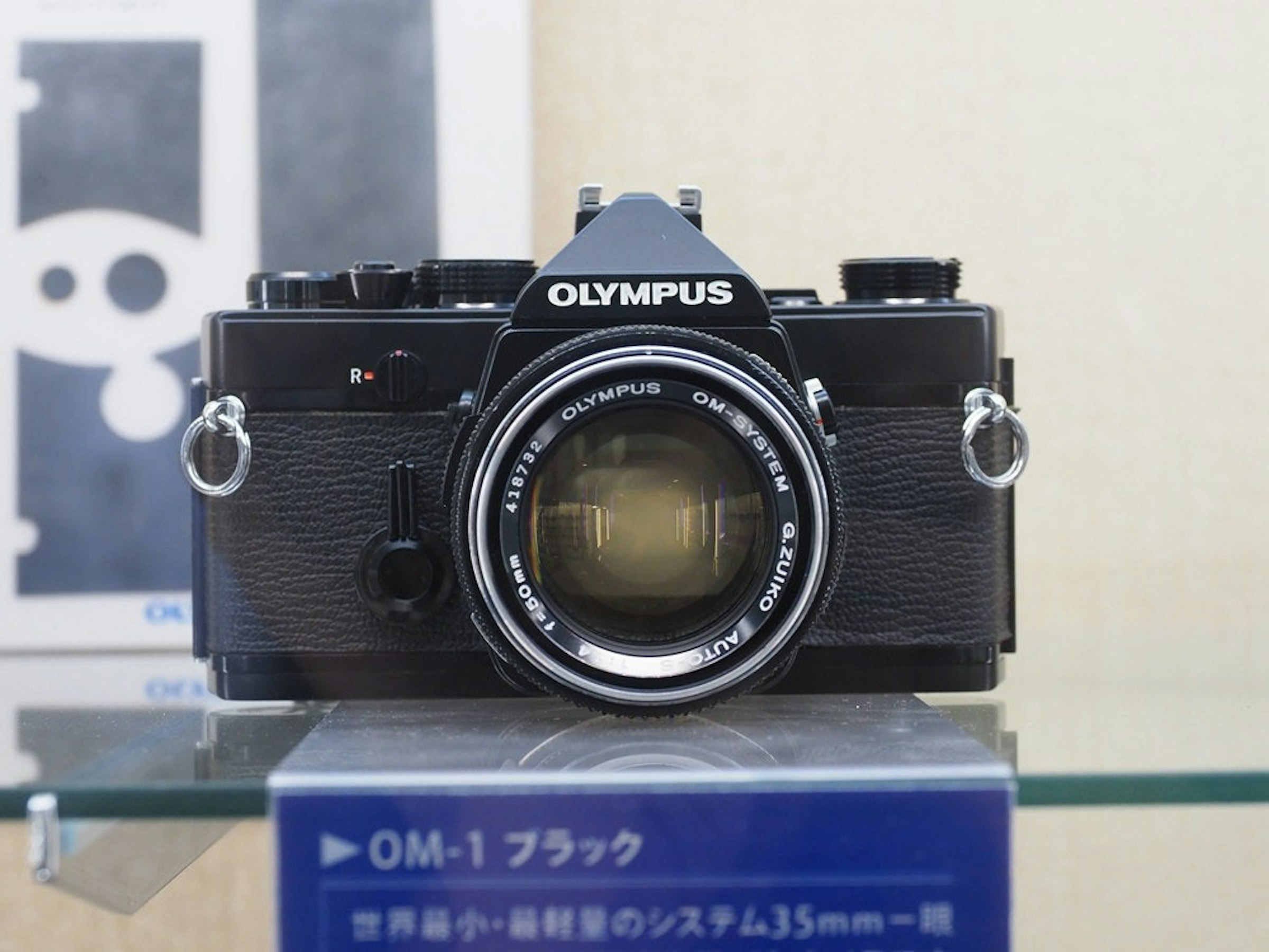 照片中提到了OLYMPUS、OM-SYSTE、OLYMPUS，包含了奧林巴斯、鏡頭、數碼單反、相機、奧林巴斯公司