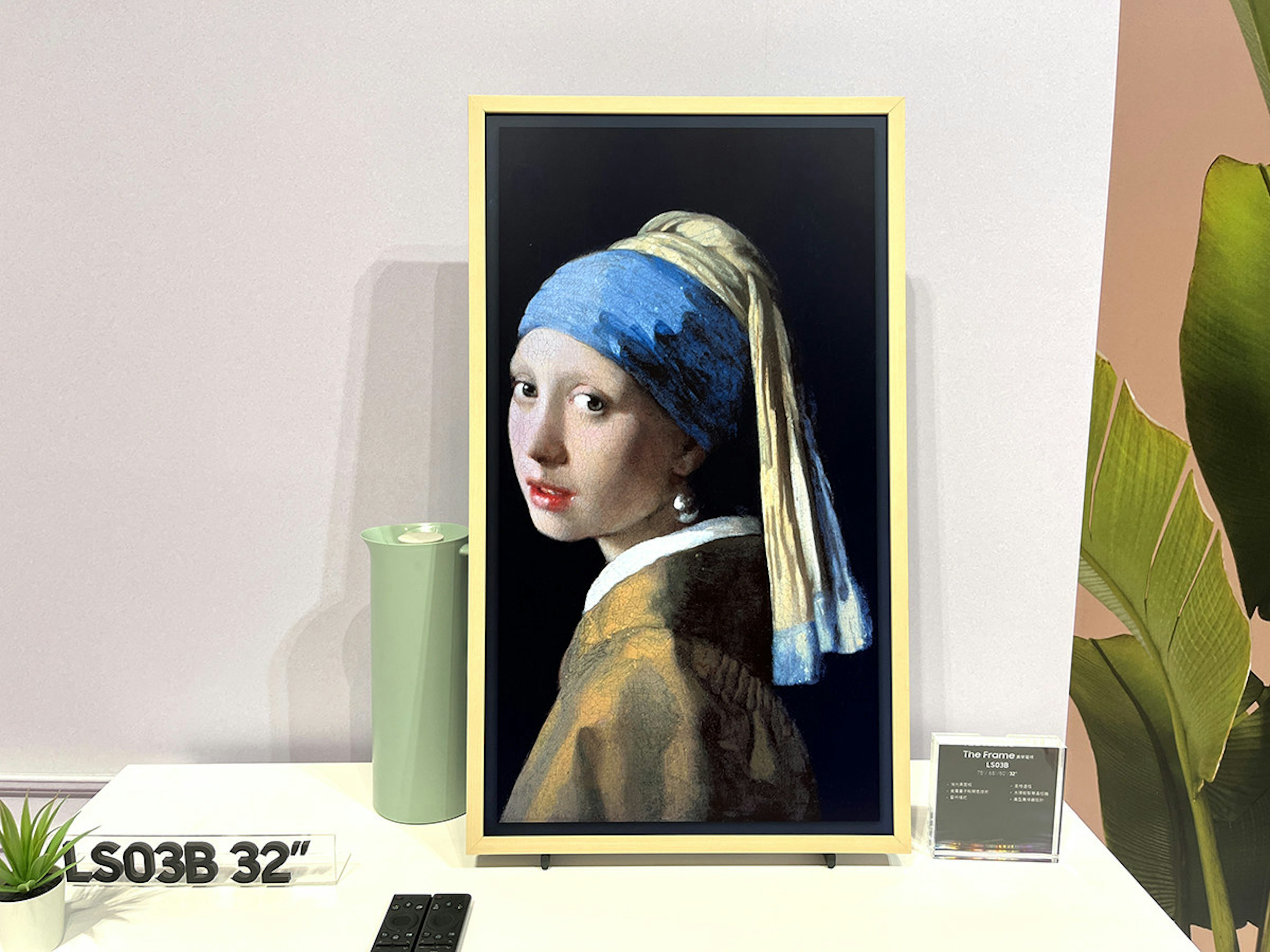 The photo mentions The Frameav, LSO3B, /66, is related to Hugo Boss, includes the girl with the pearl earring postcard, the girl with the pearl earring, t-shirt, earrings, jigsaw puzzle