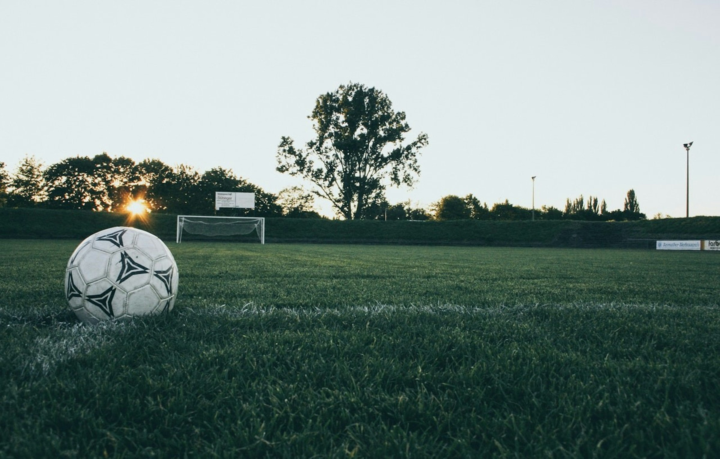 Football, Ball, Ball, Stock photography, Beach soccer, Goal, , Sports, Photograph, Offside, soccer ball photography, Soccer ball, Ball, Grass, Football, Sky, Soccer, Sports equipment, Sport venue, Team sport, Tree
