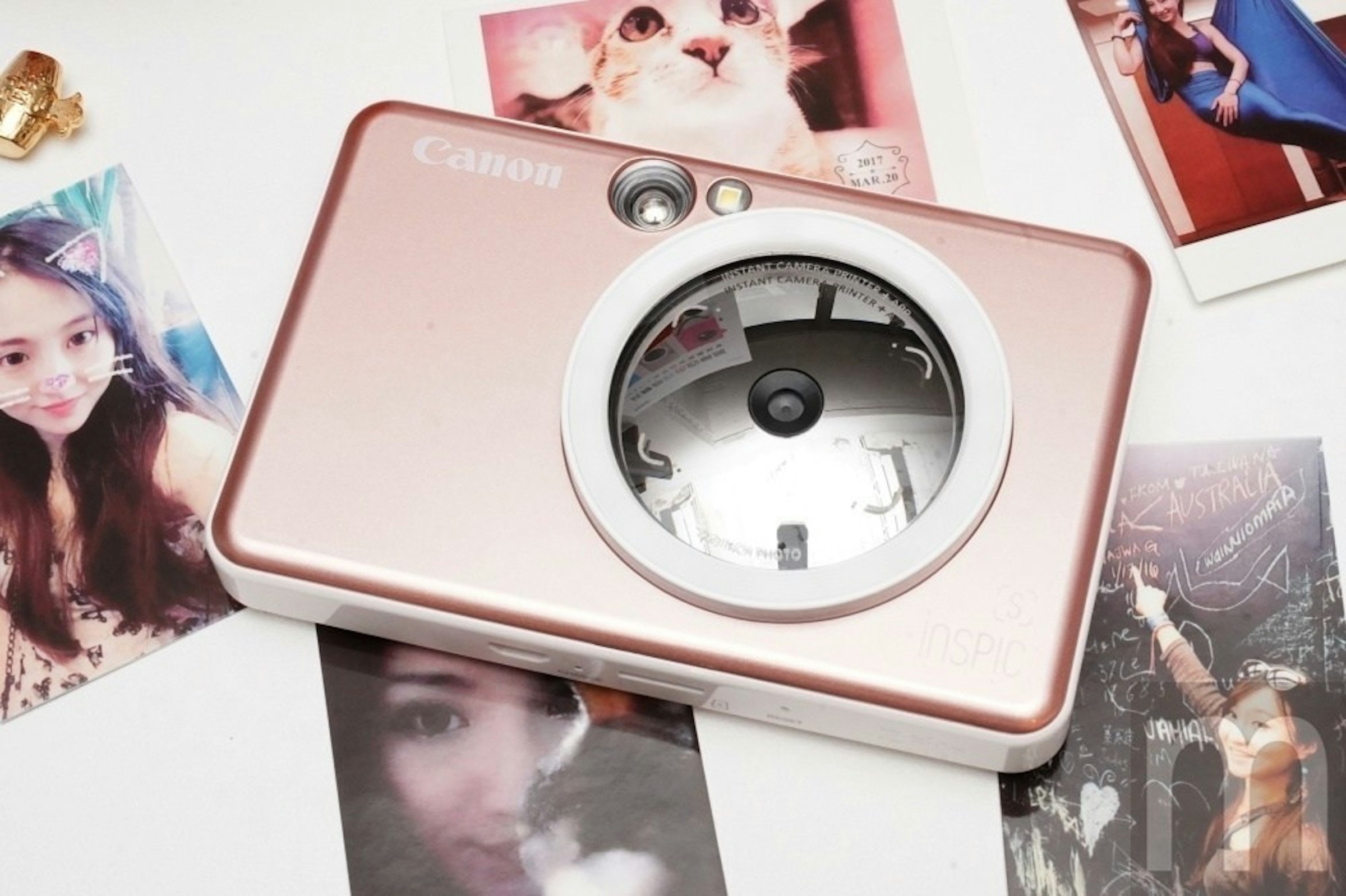 CES, Canon iNSPiC, , Canon, Polaroid Corporation, Canon IVY CLIQ Instant Camera Printer, Camera, Electronics, Camera lens, Product, gadget, Pink, Technology, Clock, Fashion accessory, Photography, Electronics, Electronic device, Watch, Alarm clock, Analog watch